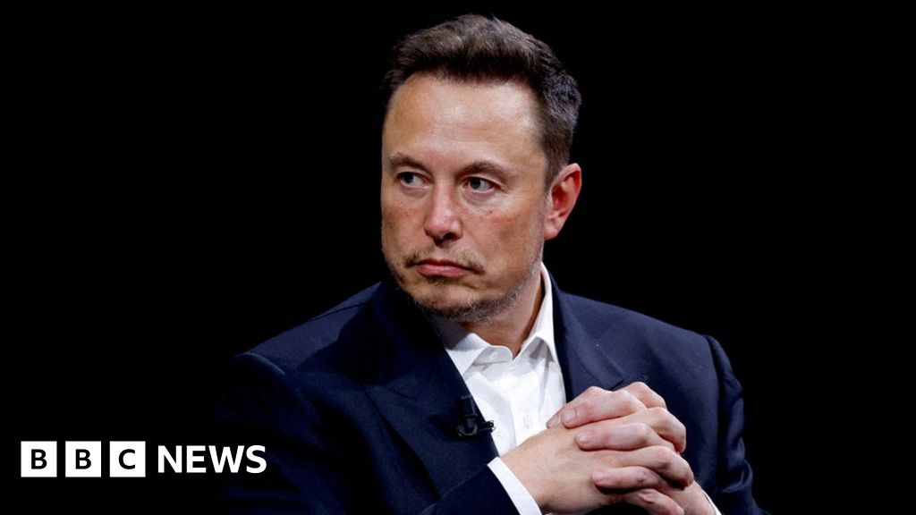 Tesla: Electric carmaker's shares slide after Musk warns of slowdown